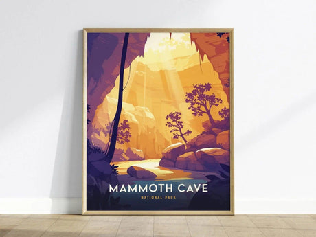 Framed poster of Mammoth Cave National Park showing a stylized cave entrance with sunlight, trees, and rocks. The artwork features warm hues and modern design, leaning against a white wall.
