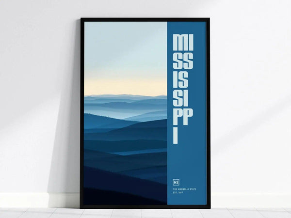 Framed poster featuring layered blue hills and bold vertical text reading Mississippi in white. The design includes subtle gradients, creating a serene and minimalist aesthetic.