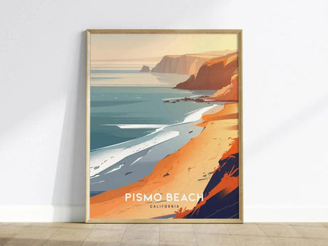 Framed poster featuring a stylized illustration of Pismo Beach, California, with vibrant sandy shores, sea cliffs, and ocean waves under a warm sunset sky.