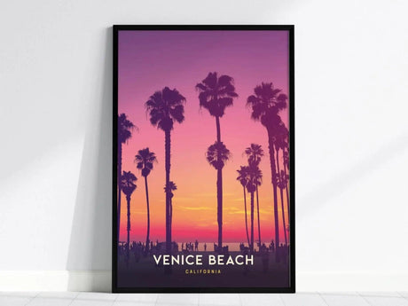 Framed poster depicting silhouettes of palm trees against a vibrant sunset sky in shades of purple, pink, and orange. The text reads Venice Beach, California.