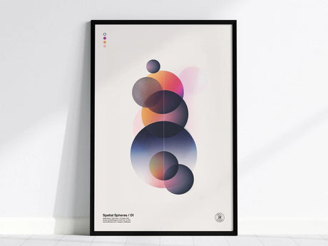 A modern abstract art poster featuring overlapping spheres with gradient transitions in shades of blue, pink, and orange, displayed in a black frame against a white wall.