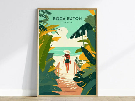 Framed wall art depicting a woman in a sun hat walking towards a beach, surrounded by tropical foliage, with Boca Raton Florida text above. The design features vibrant, soft colors.