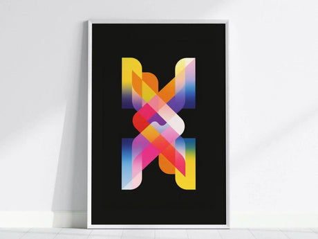 A framed poster with vibrant, overlapping geometric shapes in neon colors against a black background, displayed on a white wall. The design features gradients of yellow, pink, and blue.