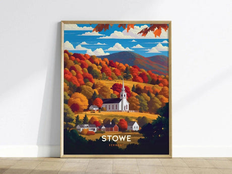 Framed poster depicting a white church steeple amidst vibrant fall foliage with red, orange, and yellow trees, set against rolling hills and a blue sky in Stowe, Vermont.