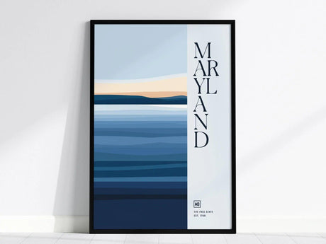A framed poster features vertical text reading Maryland alongside abstract blue and beige horizontal stripes, representing a minimalist landscape. The bottom reads The Free State Est. 1788.