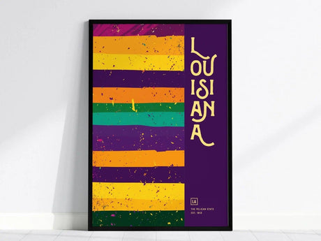 A framed poster features colorful horizontal stripes in purple, orange, and green with the word LOUISIANA in yellow text on a purple background. The design is vibrant.