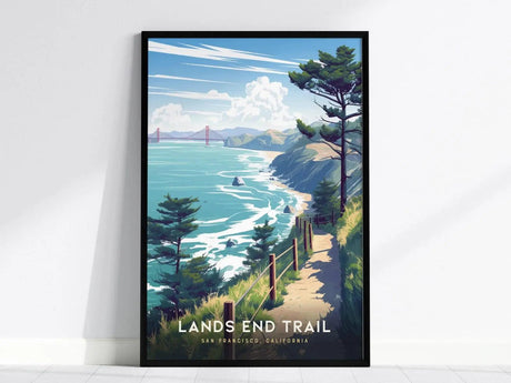 A framed poster depicting a coastal trail with ocean cliffs, cypress trees, and the Golden Gate Bridge in the distance under a blue sky.
