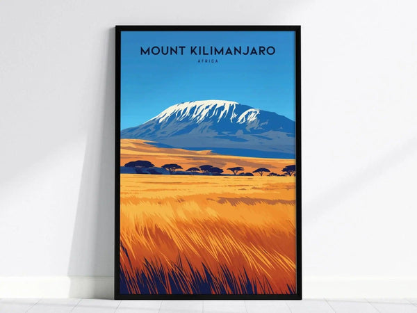 A framed poster of Mount Kilimanjaro features a snow-capped peak, vibrant blue sky, and golden savanna with acacia trees, creating a striking visual contrast.