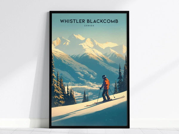 A framed poster of Whistler Blackcomb shows a skier on a snowy slope with majestic mountains and evergreen trees in the background, under a clear blue sky.