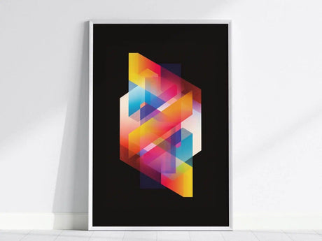A framed poster features a vibrant geometric design with overlapping neon colors on a black background, leaning against a white wall. The composition includes dynamic, angular shapes.