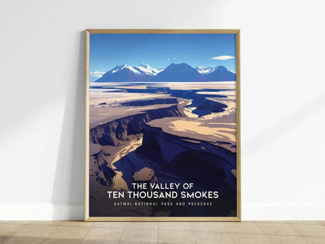 Framed poster of the Valley of Ten Thousand Smokes features a dramatic volcanic landscape with deep valleys and mountain peaks under a blue sky.