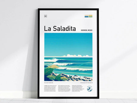 Framed poster featuring an illustrated surf scene with rolling waves and rocks under a clear blue sky, titled La Saladita with additional text and coordinates at the bottom.