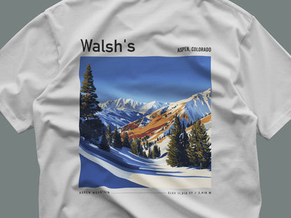 Walsh's Aspen Ski T-Shirt | Rocky Mountain Legend Art Tee — close-up of the left-chest pocket print