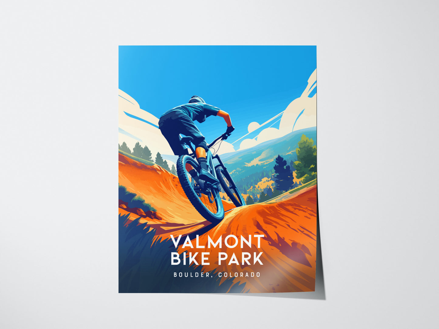 A vibrant poster depicts a mountain biker navigating a trail with colorful hills and a bright blue sky. The text reads Valmont Bike Park, Boulder, Colorado.