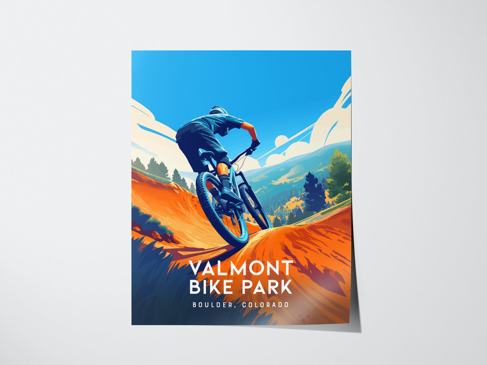 A vibrant poster depicts a mountain biker navigating a trail with colorful hills and a bright blue sky. The text reads Valmont Bike Park, Boulder, Colorado.