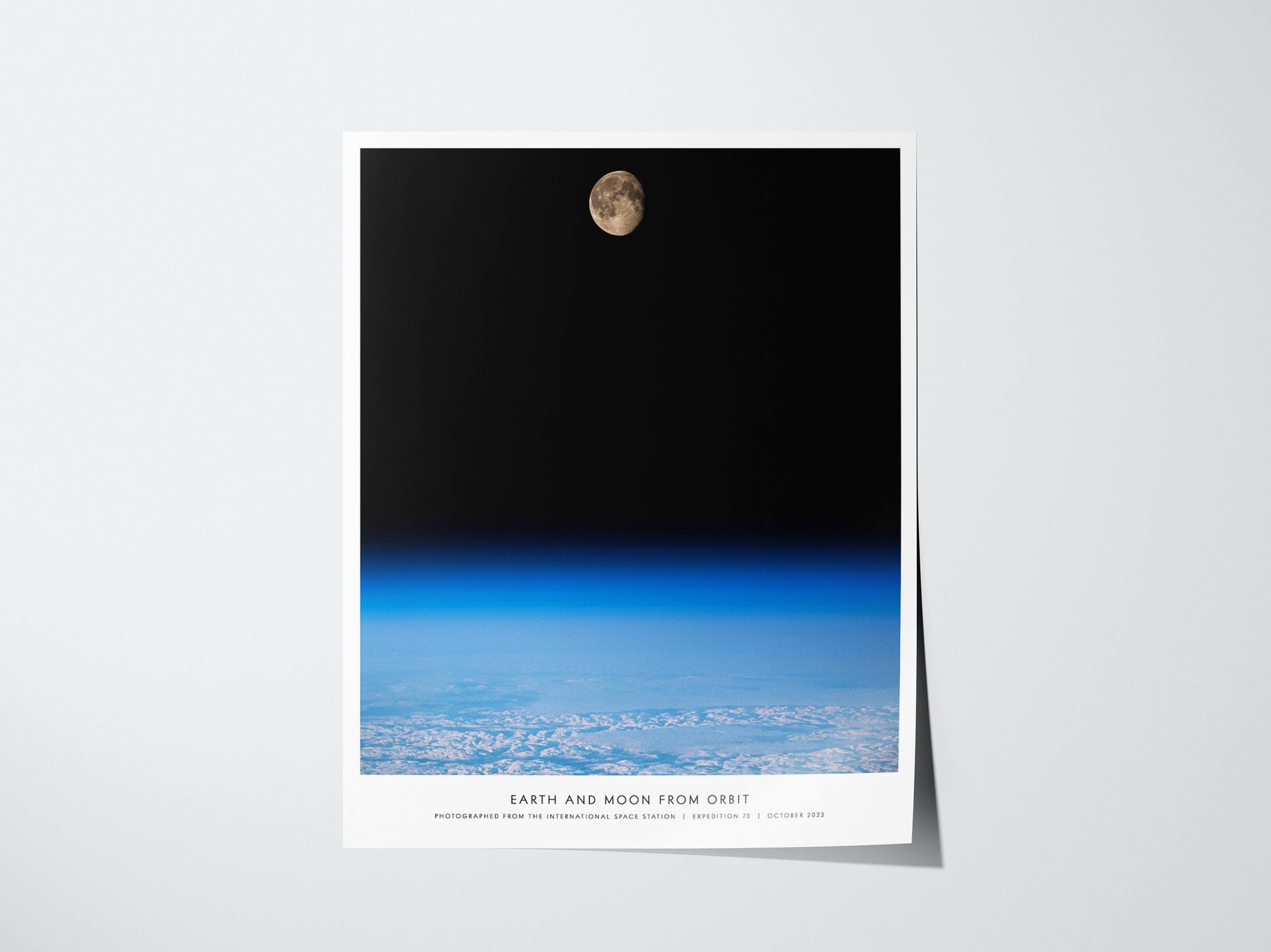 Earth and Moon Orbit NASA poster showing the Moon rising above Earth's blue horizon from orbit