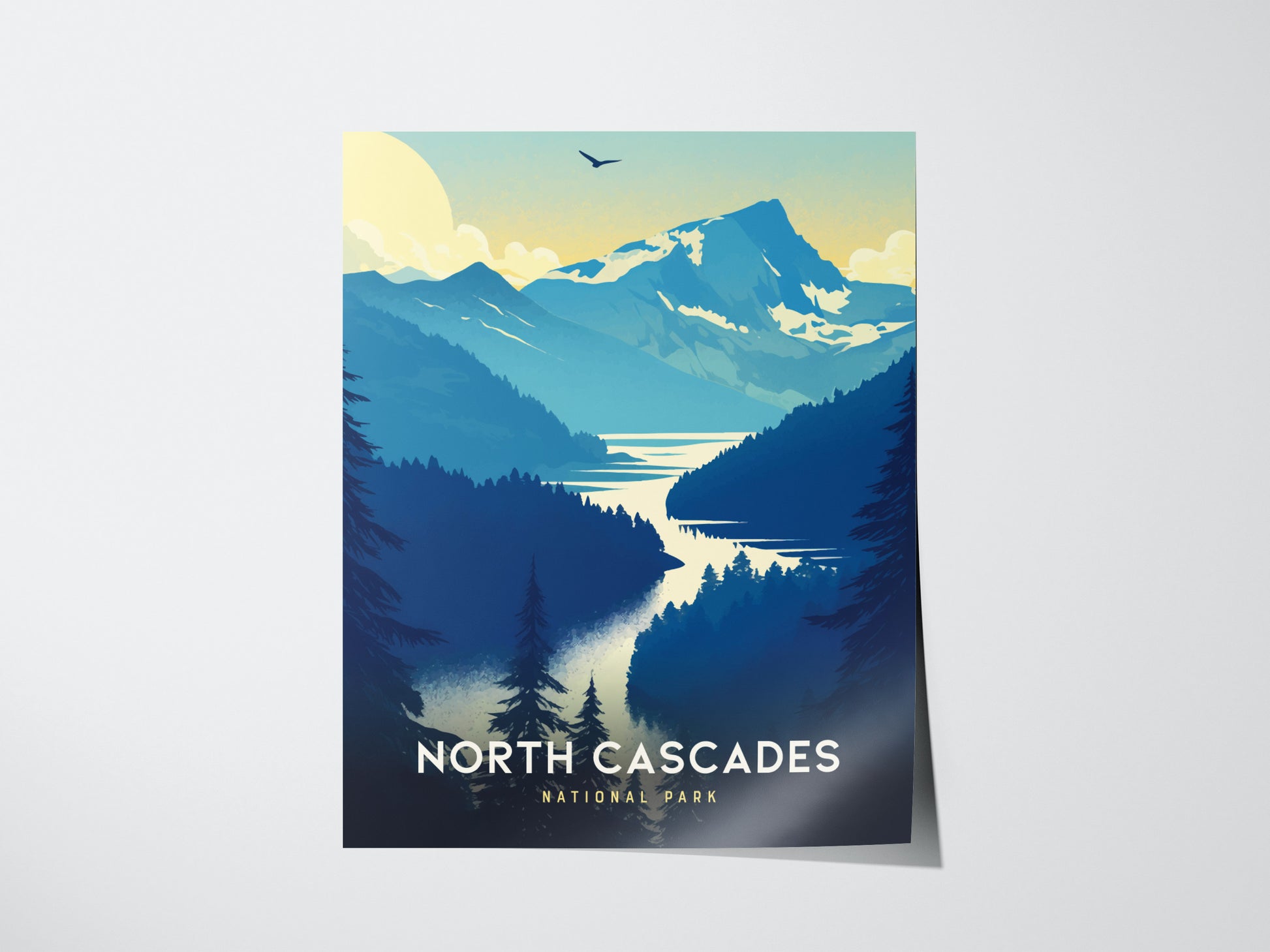 A poster depicting North Cascades National Park with stylized mountains, a winding turquoise lake, and silhouetted trees. A bird soars beneath a bright sky. Text reads North Cascades National Park.