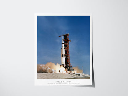 Unframed Apollo 11 launch NASA wall art hanging on a white wall in modern living room