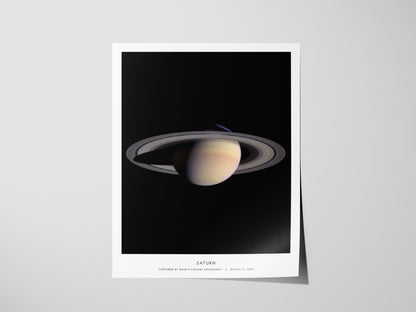 Saturn planet poster displayed in modern minimalist interior with black space aesthetic