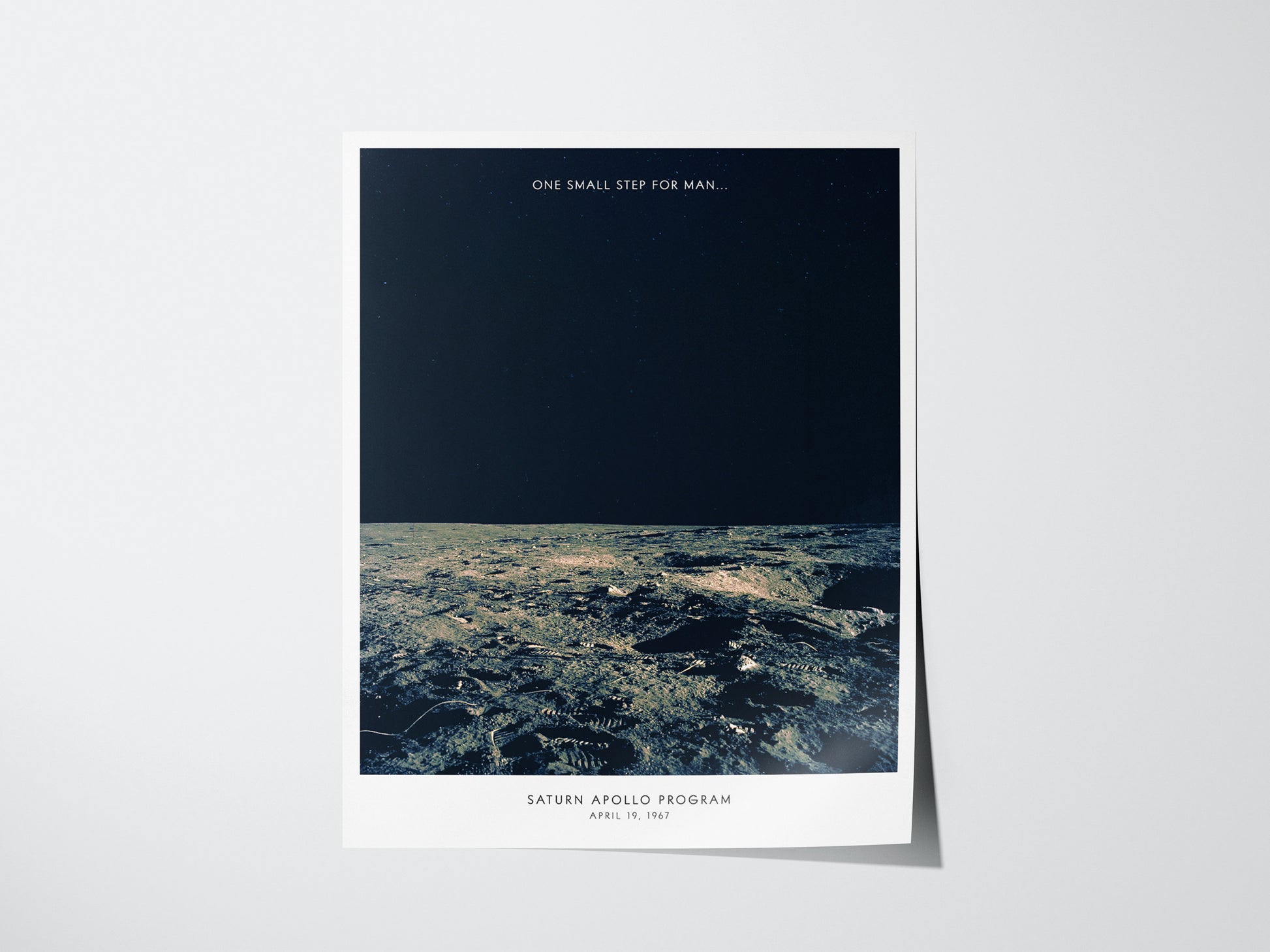 Poster of the lunar surface with text 'One Small Step for Man' from the Apollo Program on a white background.