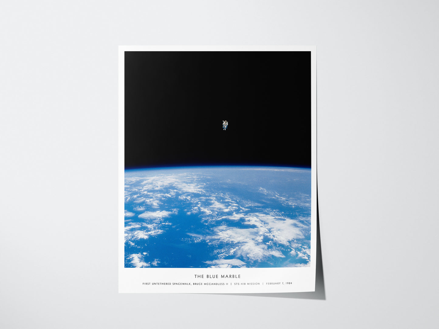 Blue Marble NASA spacewalk poster featuring astronaut floating above Earth in orbit
