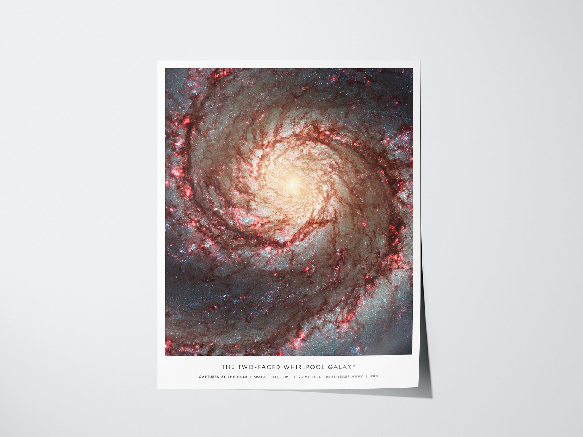Poster of a spiral galaxy titled 'The Two-Faced Whirlpool Galaxy' on a white background