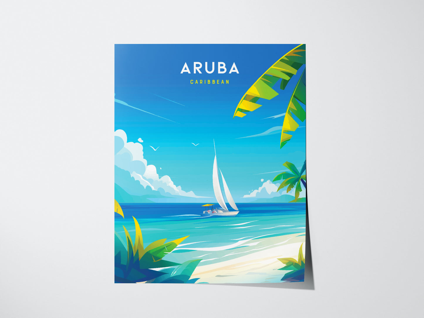 A vibrant poster of Aruba features a sailboat on turquoise waters, with palm trees and a clear blue sky. The word Aruba is prominently displayed at the top.