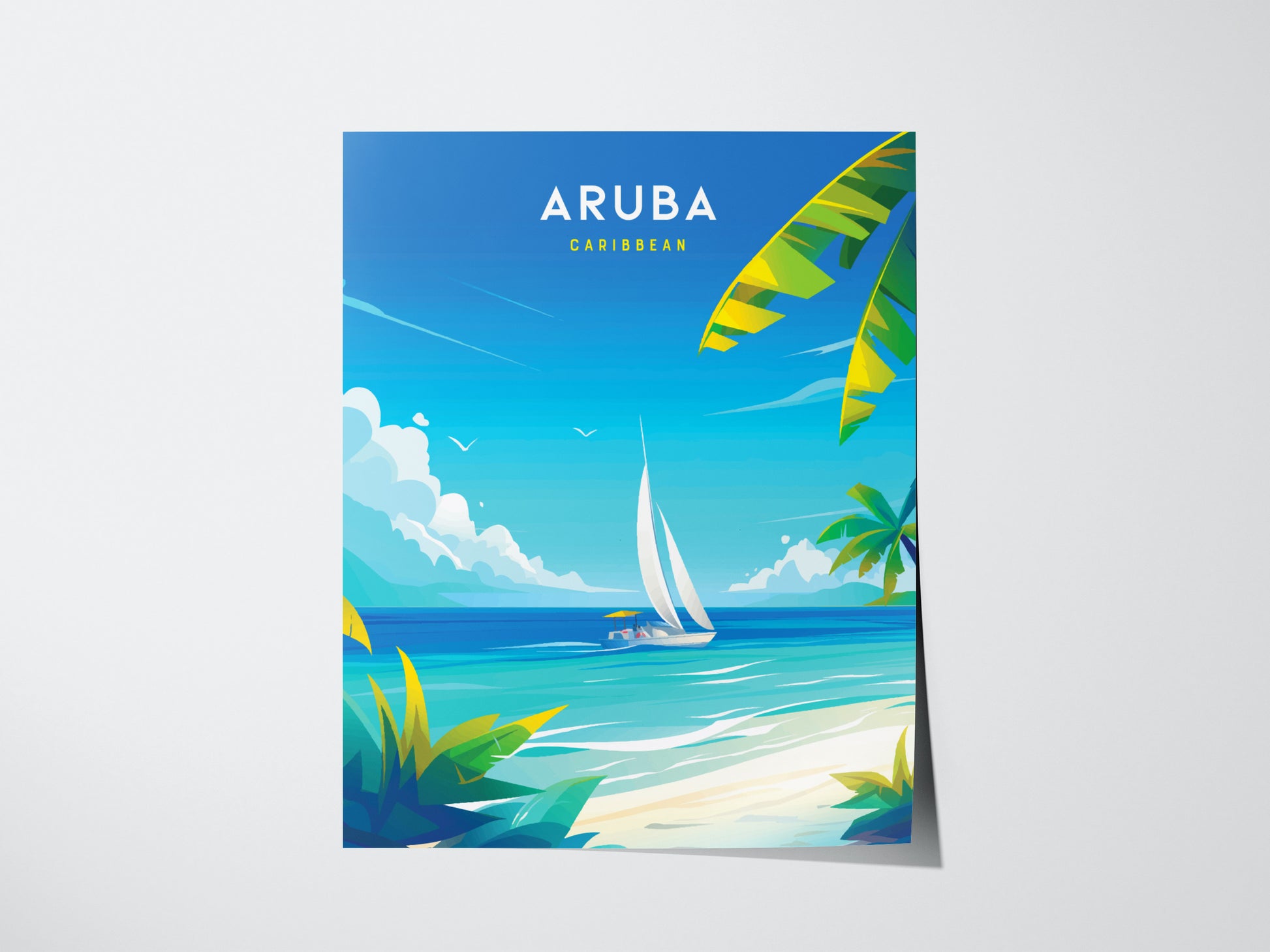 A vibrant poster of Aruba features a sailboat on turquoise waters, with palm trees and a clear blue sky. The word Aruba is prominently displayed at the top.