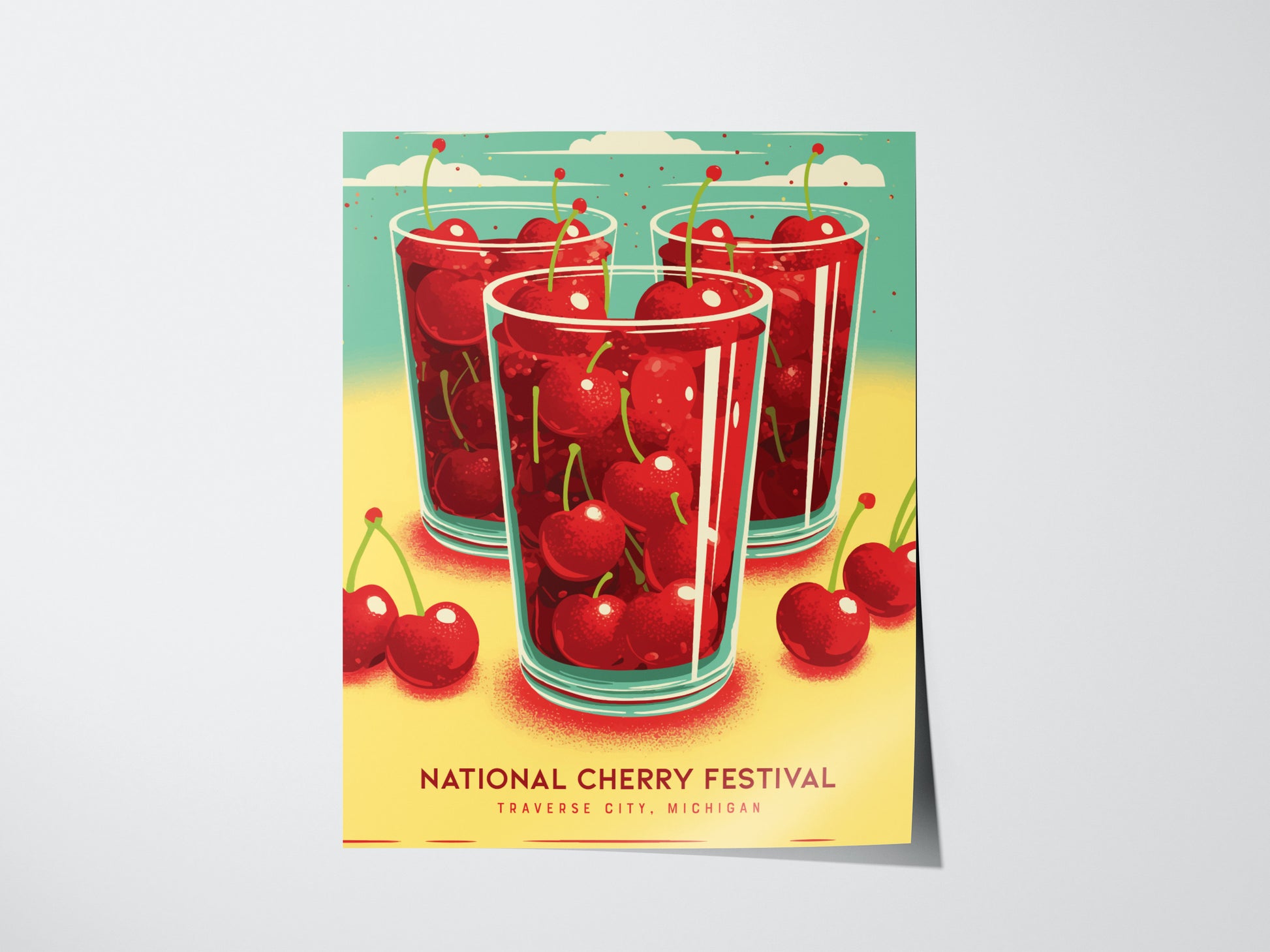 A colorful poster featuring three glasses filled with red cherries against a bright teal and yellow background. The text reads National Cherry Festival, Traverse City, Michigan.