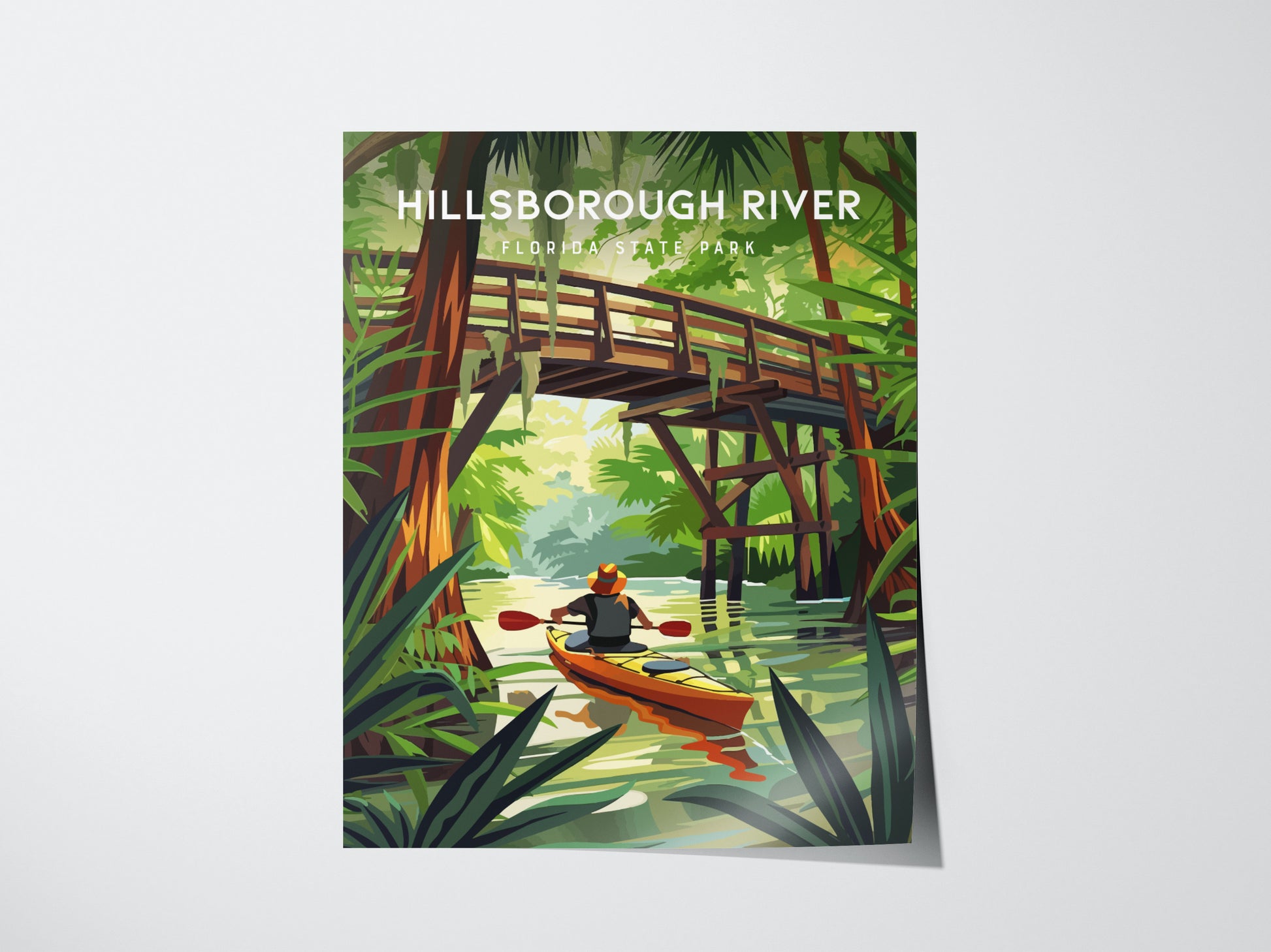 A vibrant illustration shows a kayaker paddling under a wooden bridge on a lush river, surrounded by green foliage and tall trees. The text reads Hillsborough River Florida State Park.
