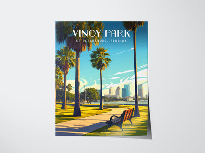 Illustrated poster of Vinoy Park, featuring a scenic pathway lined with palm trees, a bench, and a view of the St. Petersburg skyline under a bright blue sky.