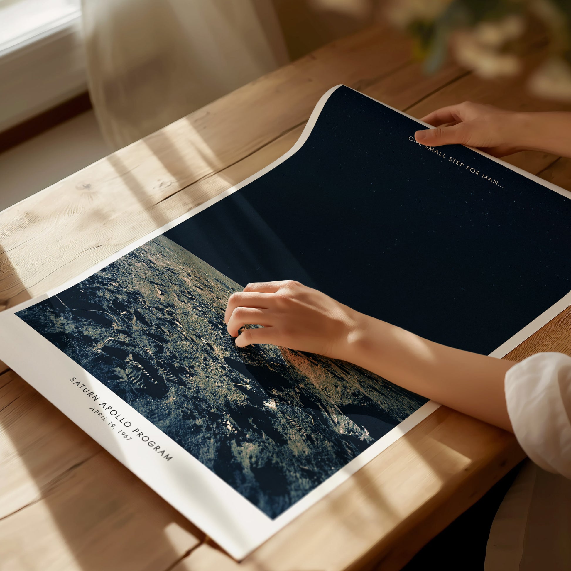 Unframed Apollo 12 Moon Landing NASA poster printed on matte archival paper on a flat surface