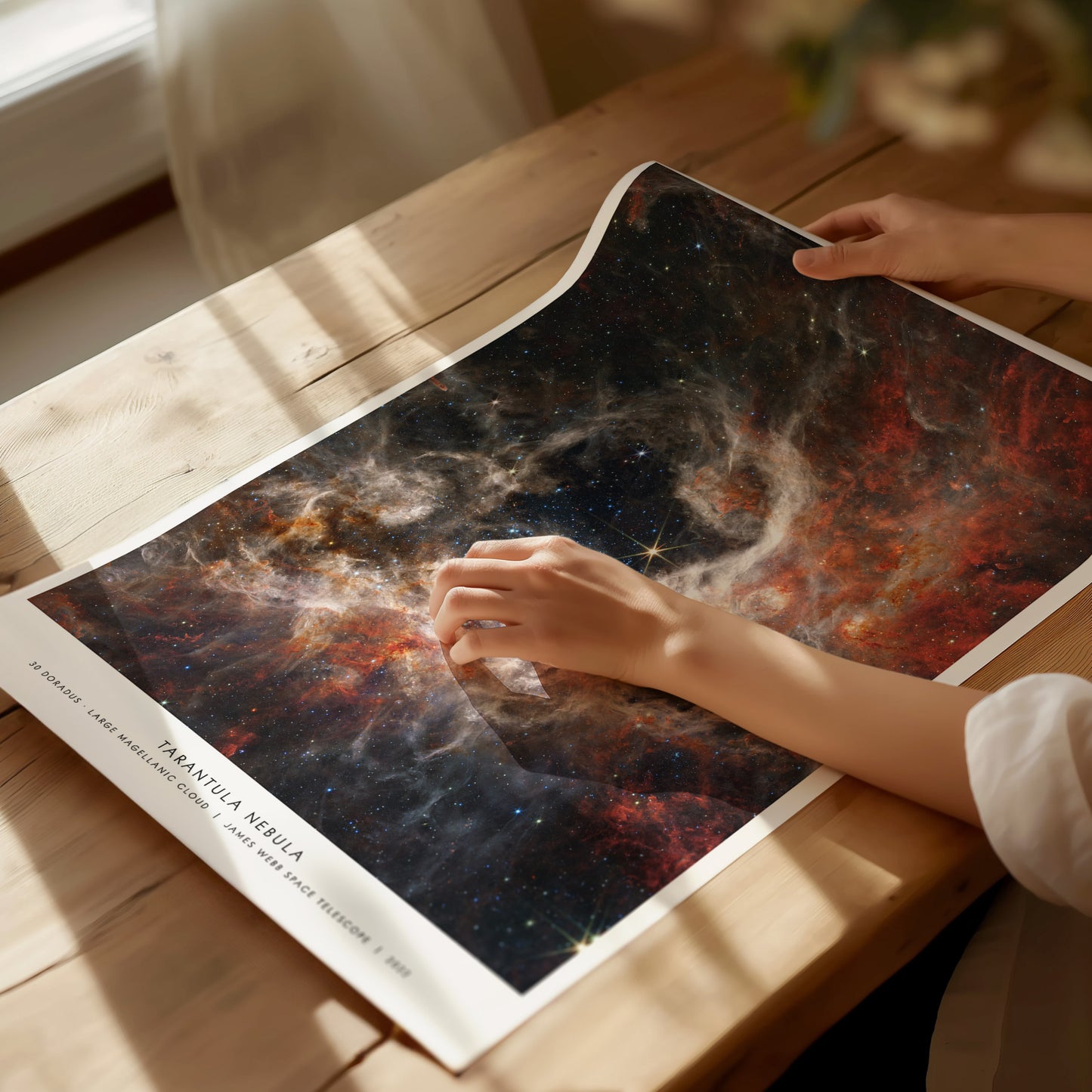 Unframed Tarantula Nebula NASA poster printed on matte archival paper laid flat on a tabletop