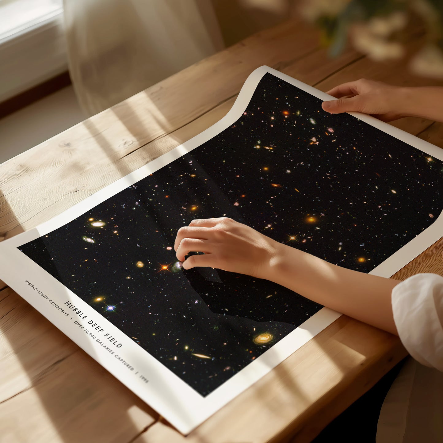 Person holding a poster of Hubble Deep Field 