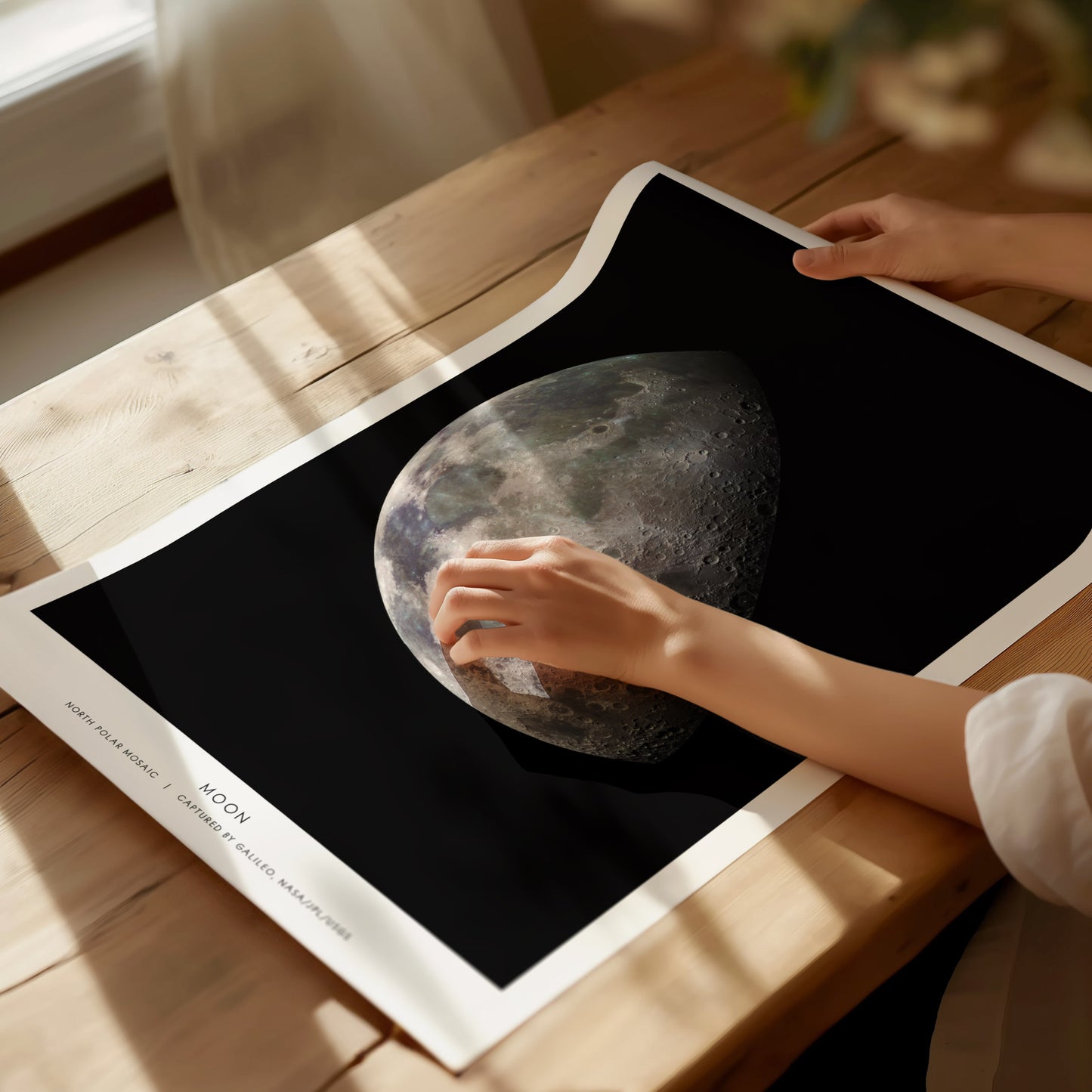 Unframed Moon NASA poster printed on matte archival paper laid flat on a tabletop