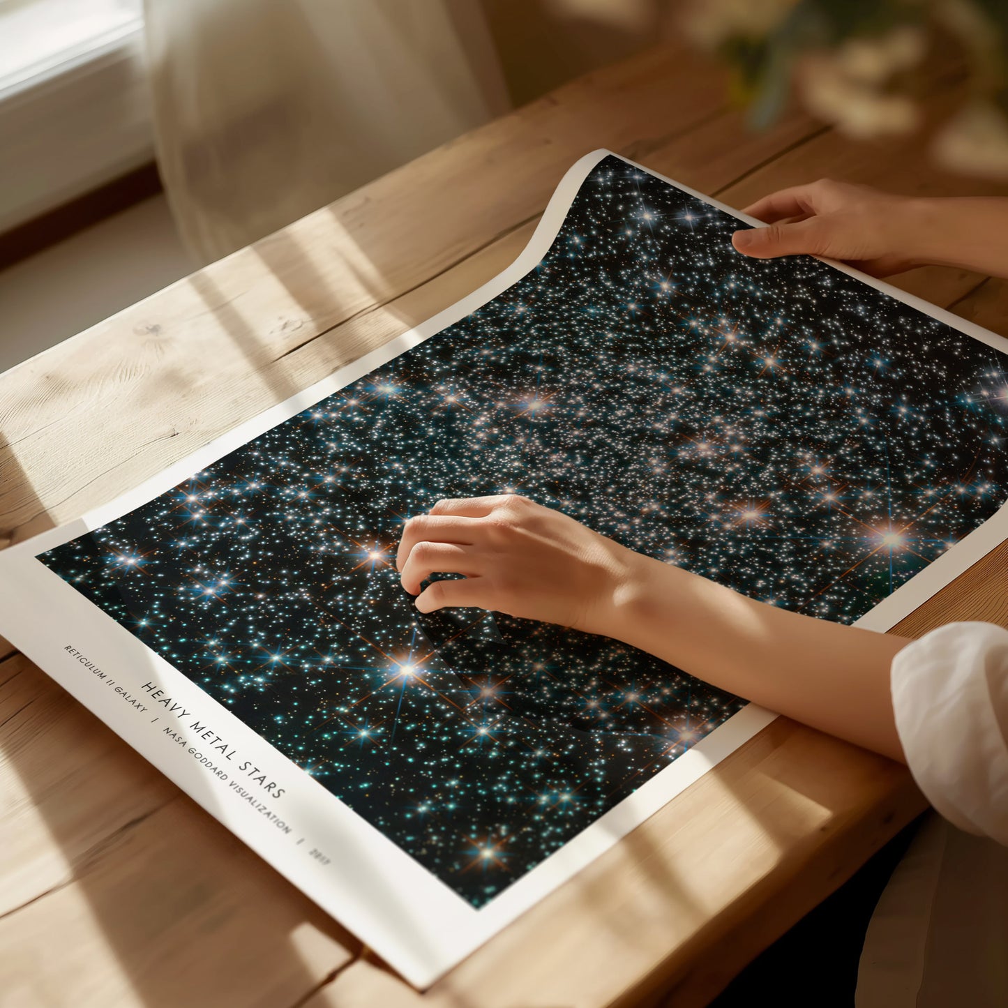 Unframed Heavy Metal Stars NASA poster printed on matte archival paper laid flat on a tabletop