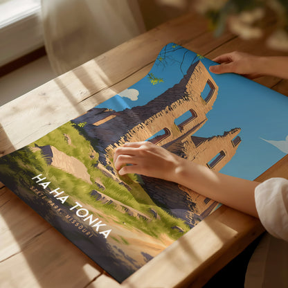 A person examines a vibrant poster depicting Ha Ha Tonka State Park, Missouri, showing a stone structure against a clear blue sky. The poster is laid on a wooden table.