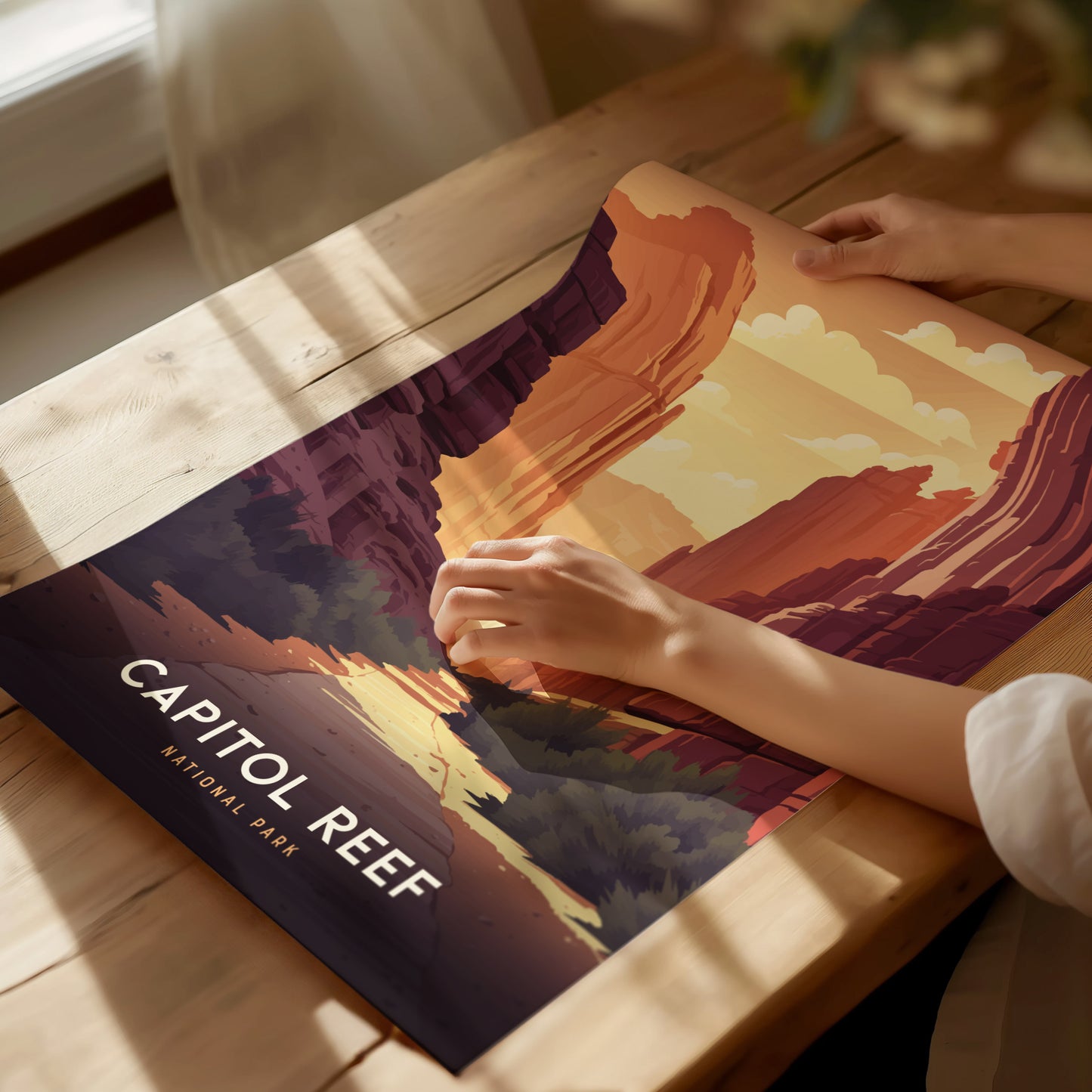 A person is holding a vibrant Capitol Reef National Park poster featuring colorful desert canyons and cliffs.