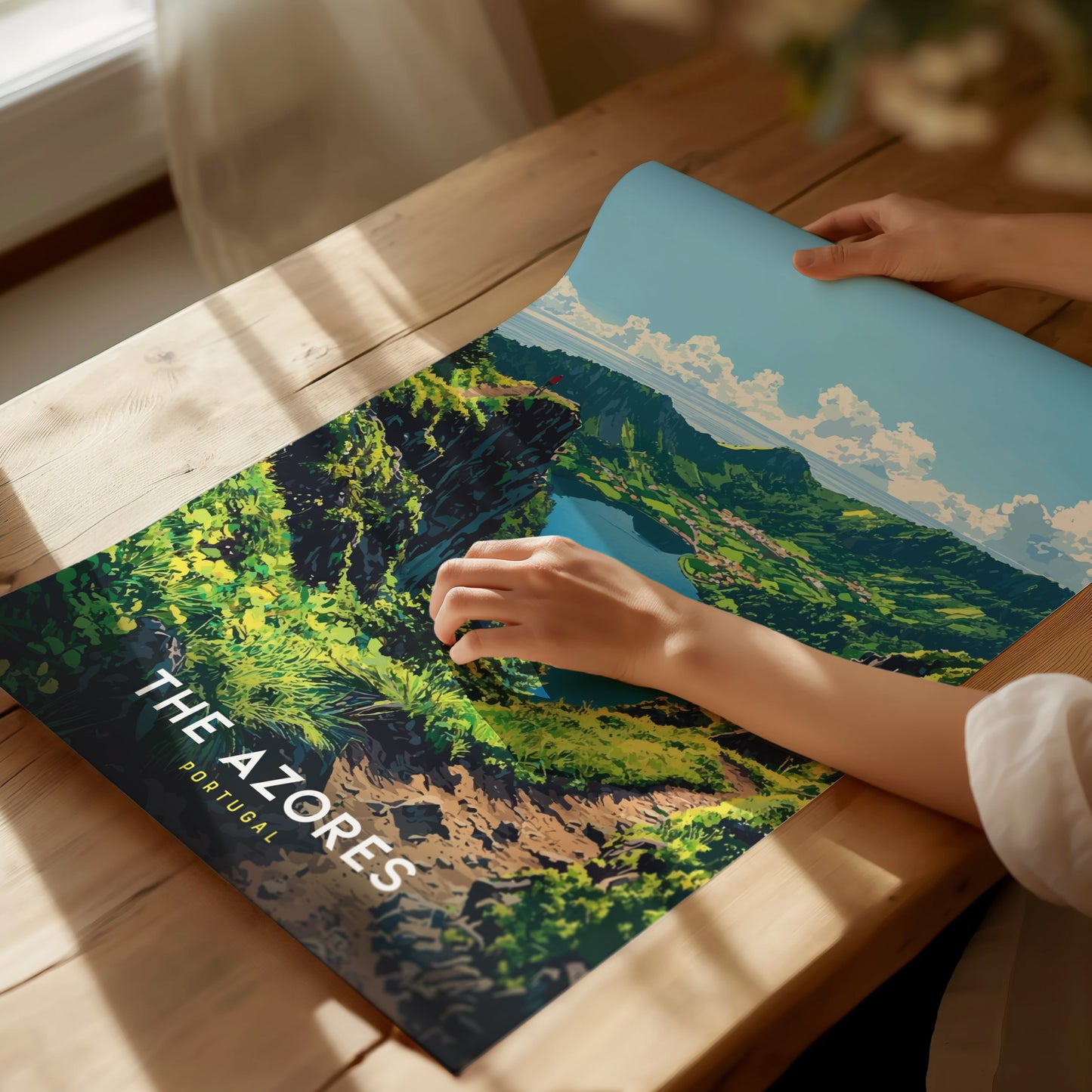 Person holding a laptop with a scenic design of The Azores on a wooden surface