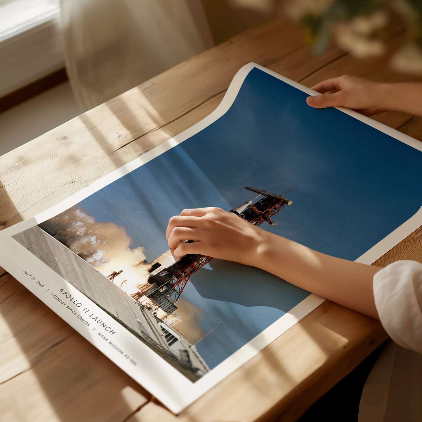 Unframed Apollo 11 launch NASA poster printed on matte archival paper laid flat on tabletop
