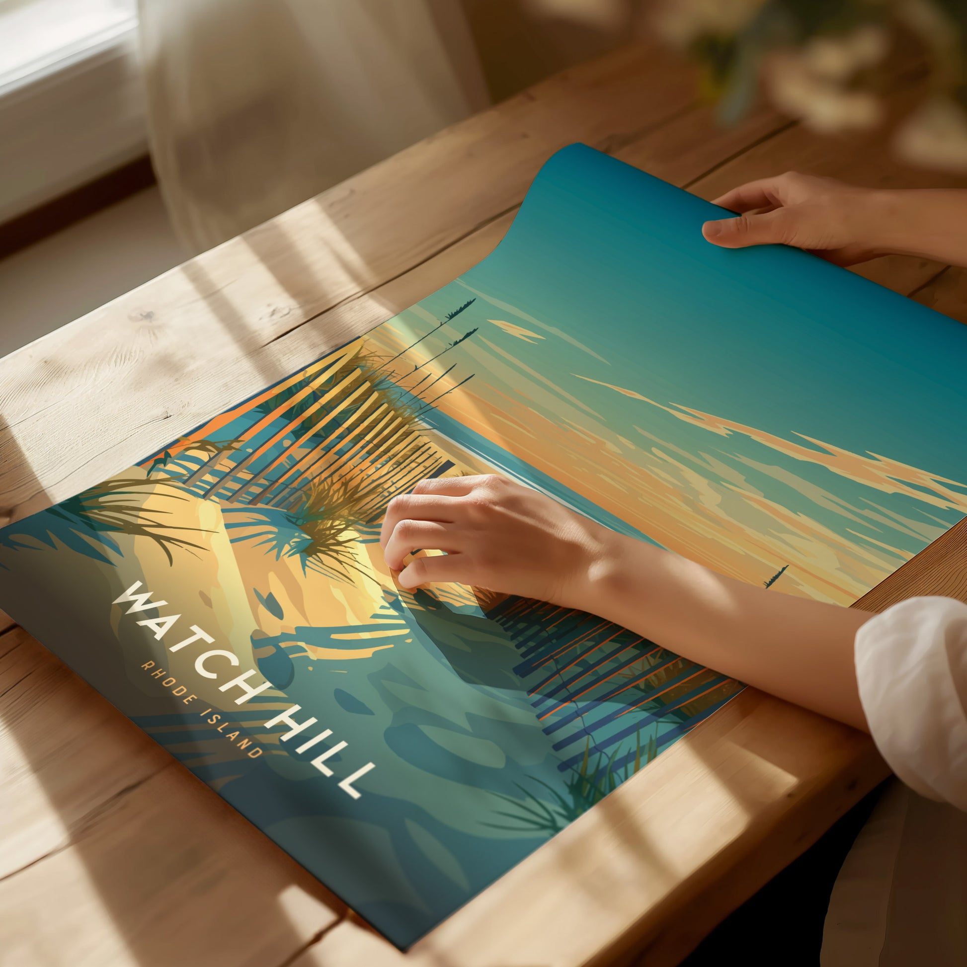 A person unrolls a vibrant Watch Hill Rhode Island poster depicting a coastal scene with sandy beaches and blue waters, on a sunlit wooden table.