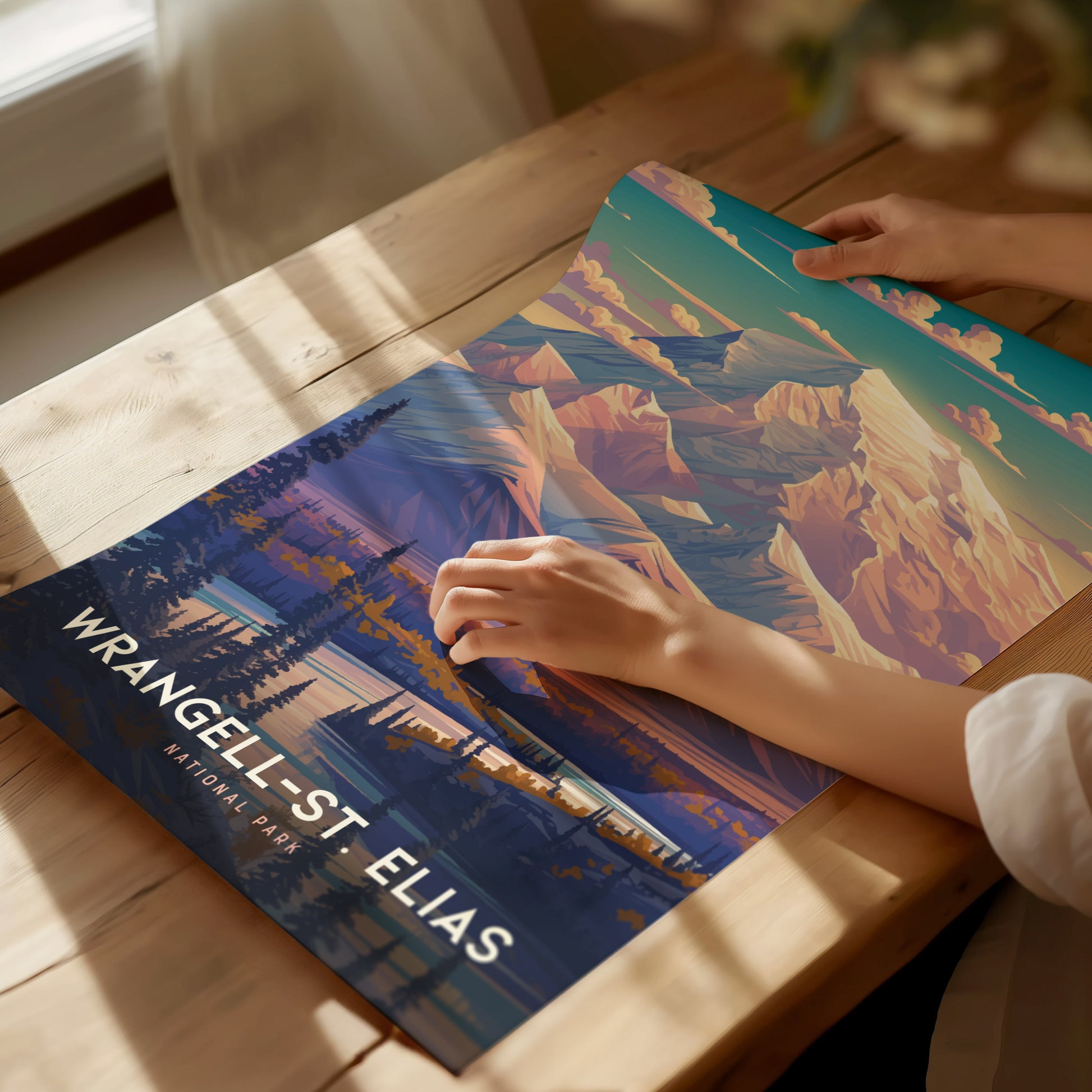 A person is holding a colorful poster of Wrangell-St. Elias National Park, featuring vibrant mountain peaks and forests.