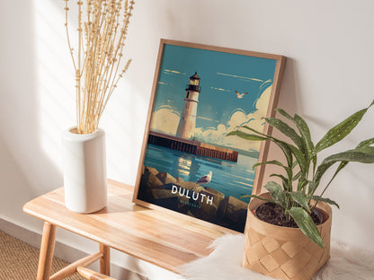A framed poster of the Duluth Harbor North Pier Lighthouse is displayed on a wooden bench, surrounded by a white vase with dried flowers and a potted green plant.