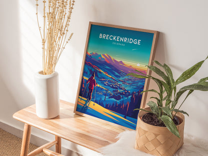 A framed Breckenridge Colorado ski poster rests on a wooden bench, accompanied by a white vase with dried flowers and a green potted plant, creating a cozy, decorative corner.