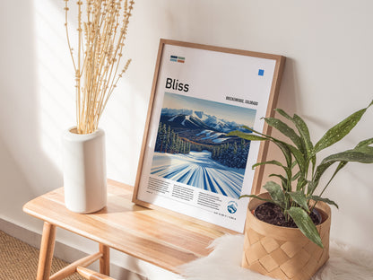 A framed ski run poster of Breckenridge, Colorado, rests on a wooden bench beside a white vase with dried flowers and a potted plant, illuminated by soft sunlight.
