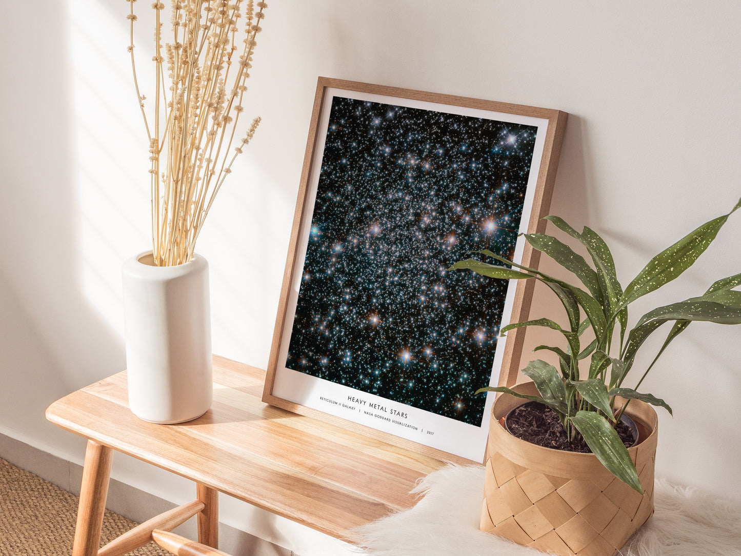 Natural wood framed Heavy Metal Stars NASA print displayed on a shelf beside plants and neutral accessories