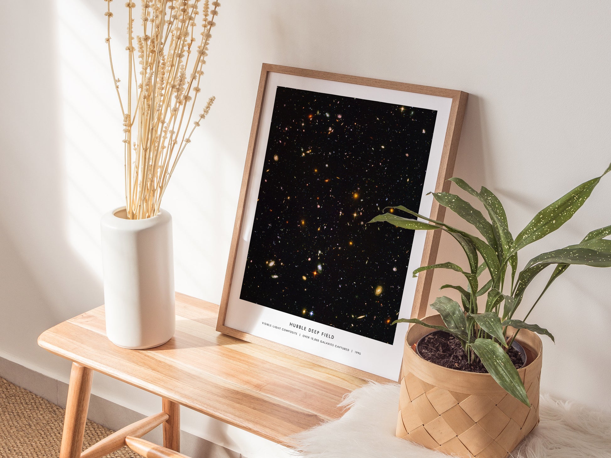 Framed Hubble Deep Field NASA wall art hanging on a white wall in a modern living room