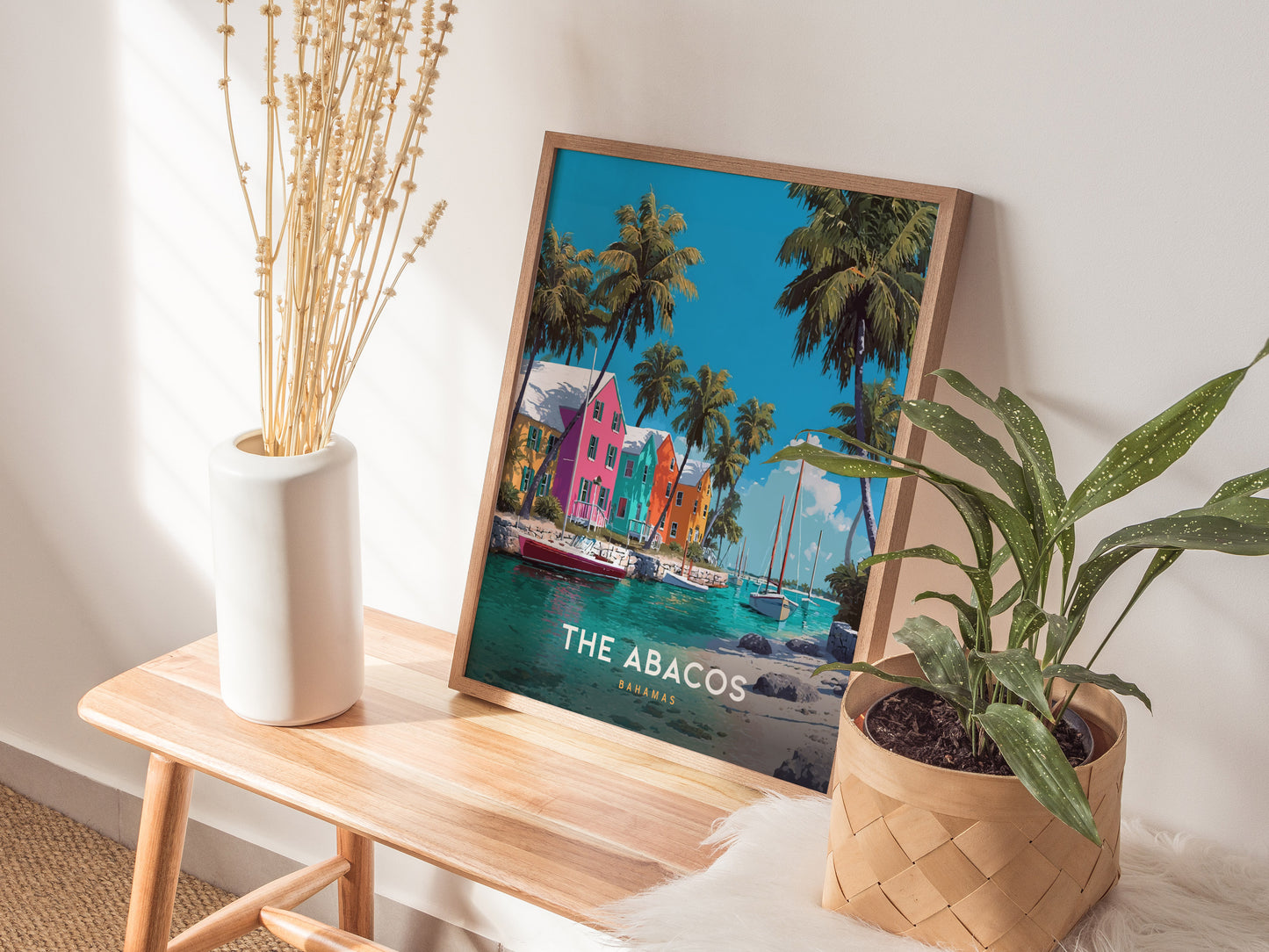 Vibrant poster of The Abacos, Bahamas, featuring colorful waterfront buildings, palm trees, and boats in a serene tropical scene.