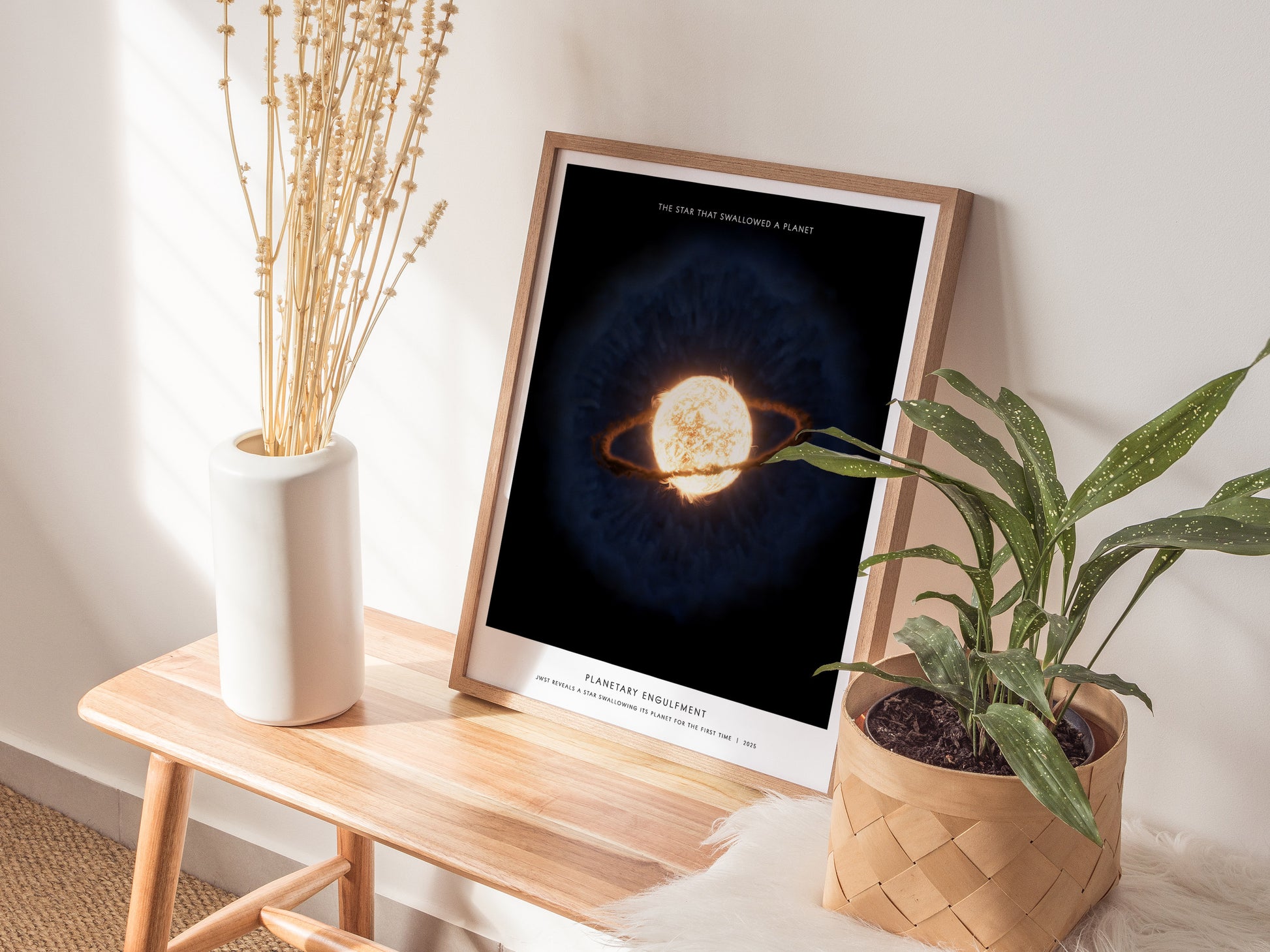 Natural wood framed Planetary Engulfment space print leaning on a shelf next to plants and neutral accessories