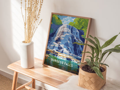 A framed poster of Burgess Falls, featuring cascading water and lush greenery, is displayed on a wooden bench next to a potted plant and a white vase with dried flowers.
